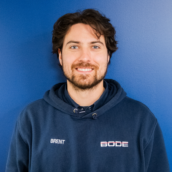 Brent Beaudoin headshot with blue wall and BODE hoodie