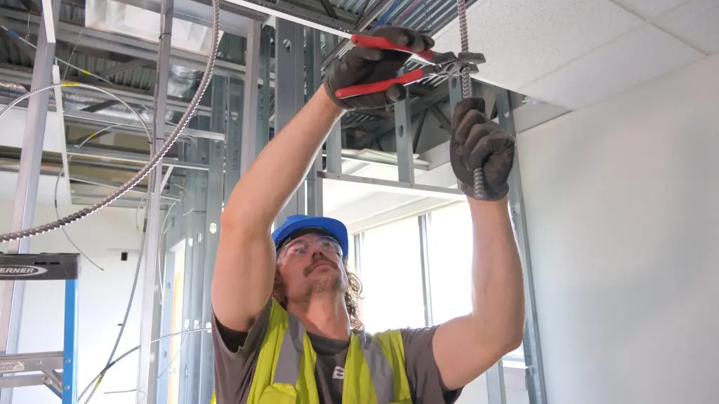 bode electrician working on conduit