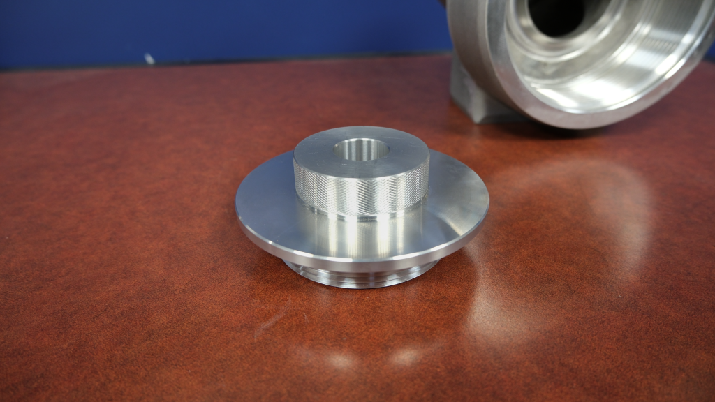 picture of an aluminum fitting cap on a wooden table