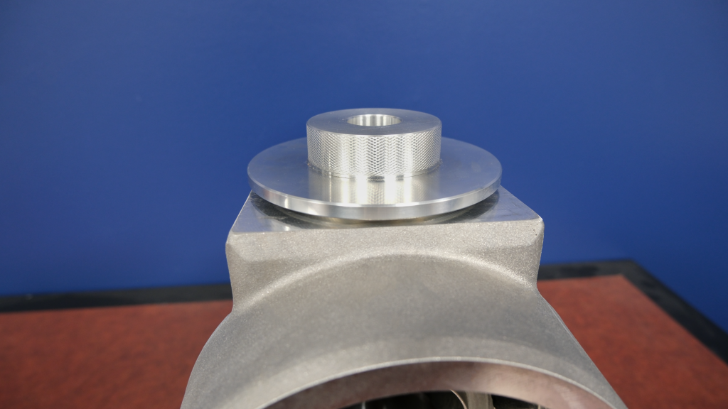 picture of an aluminum fitting cap on a wooden table